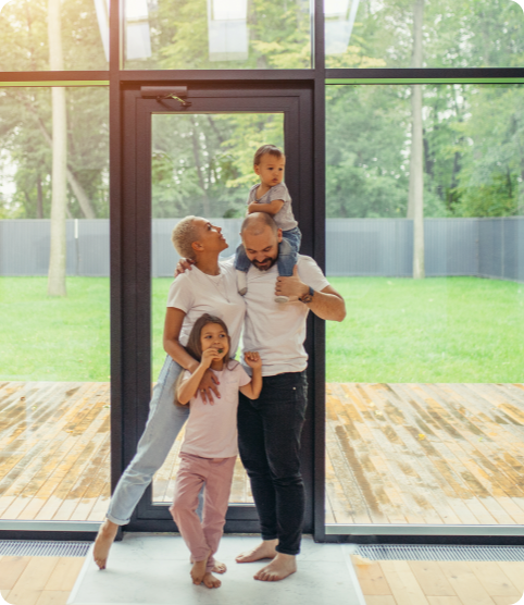 Family standing in a home near a window