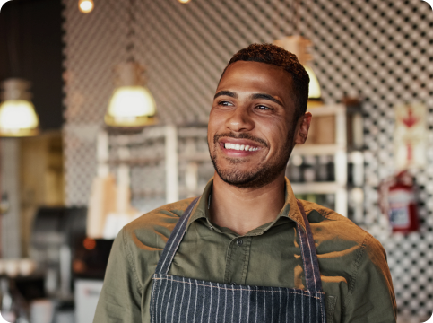 Man wearing an apron in a restaurant