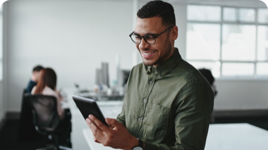 Man smiling looking at tablet