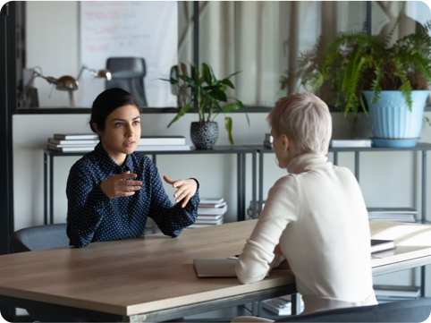 Two women sitting at a table having a conversation