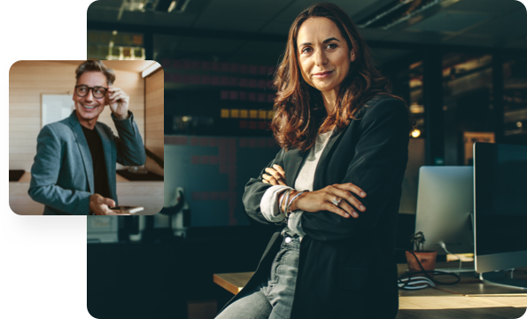 Man adjusting his glasses, woman sitting on desk