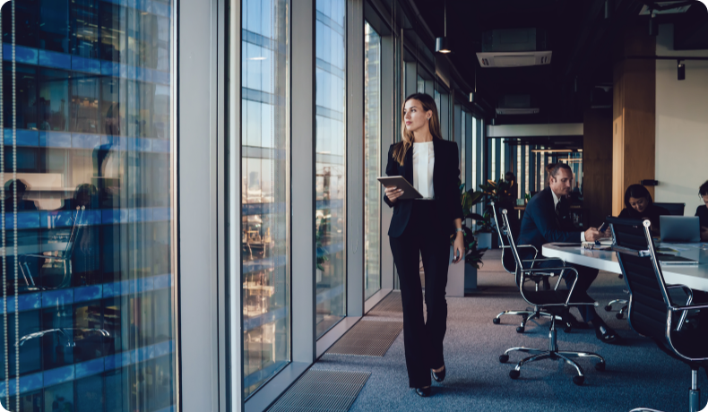 Business woman walking alongside windows