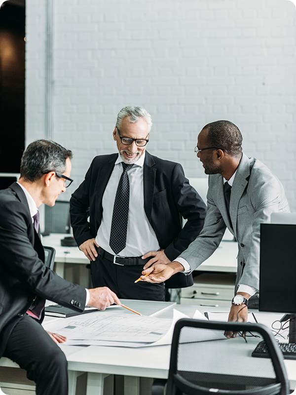 Businessmen smiling, looking at business plans