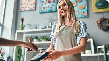 Small business owner smiling at customer
