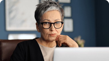 Woman looking at laptop with concern