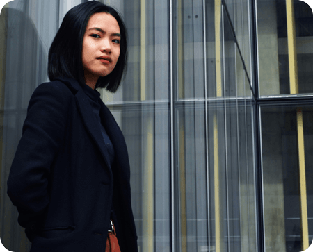 Woman standing next to window